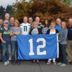 A group of people holding up a flag.